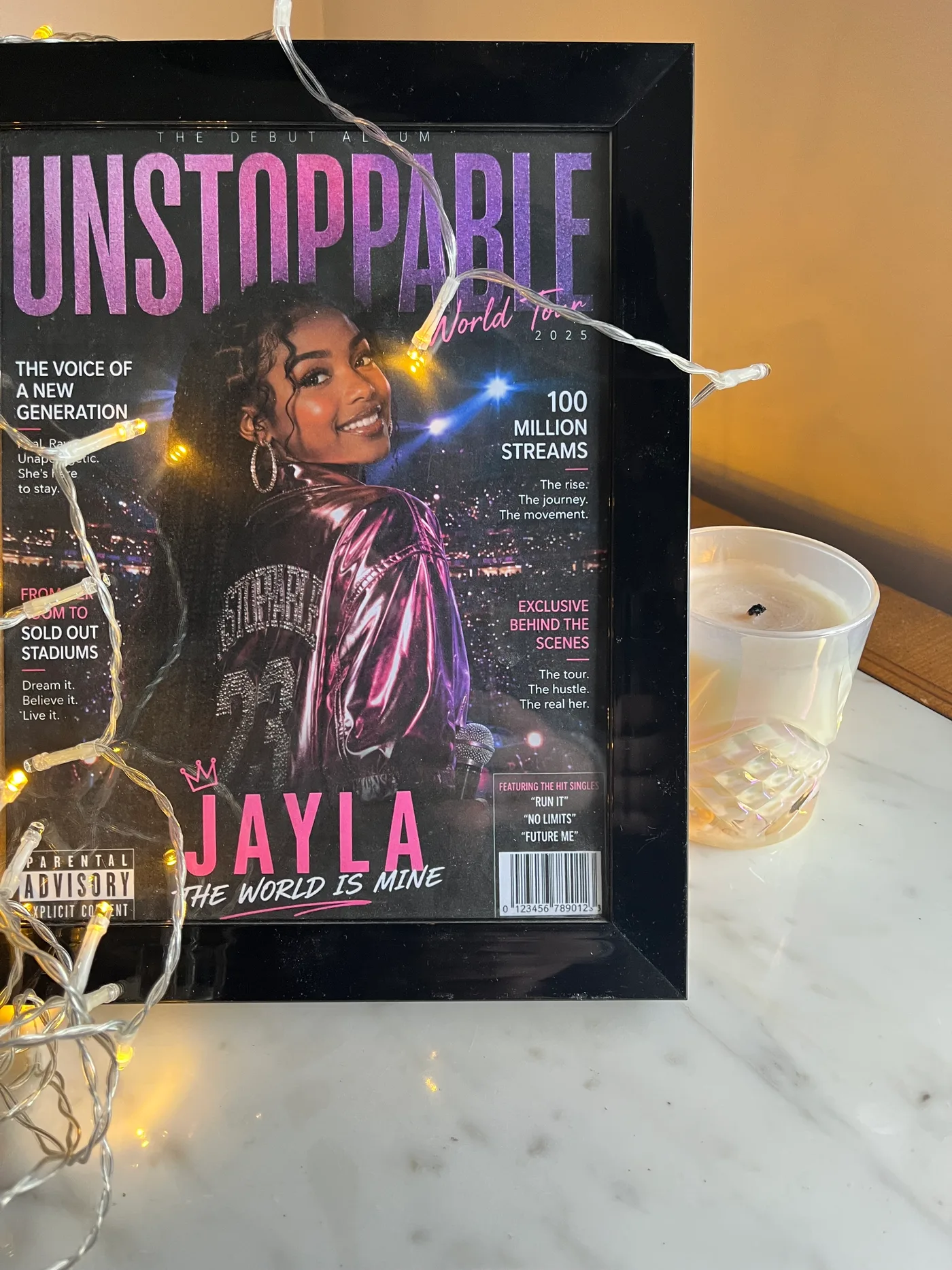 Framed pop star cover portrait displayed with string lights