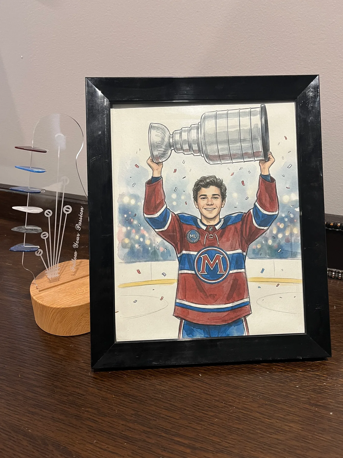 Framed illustrated championship hockey portrait displayed on a table